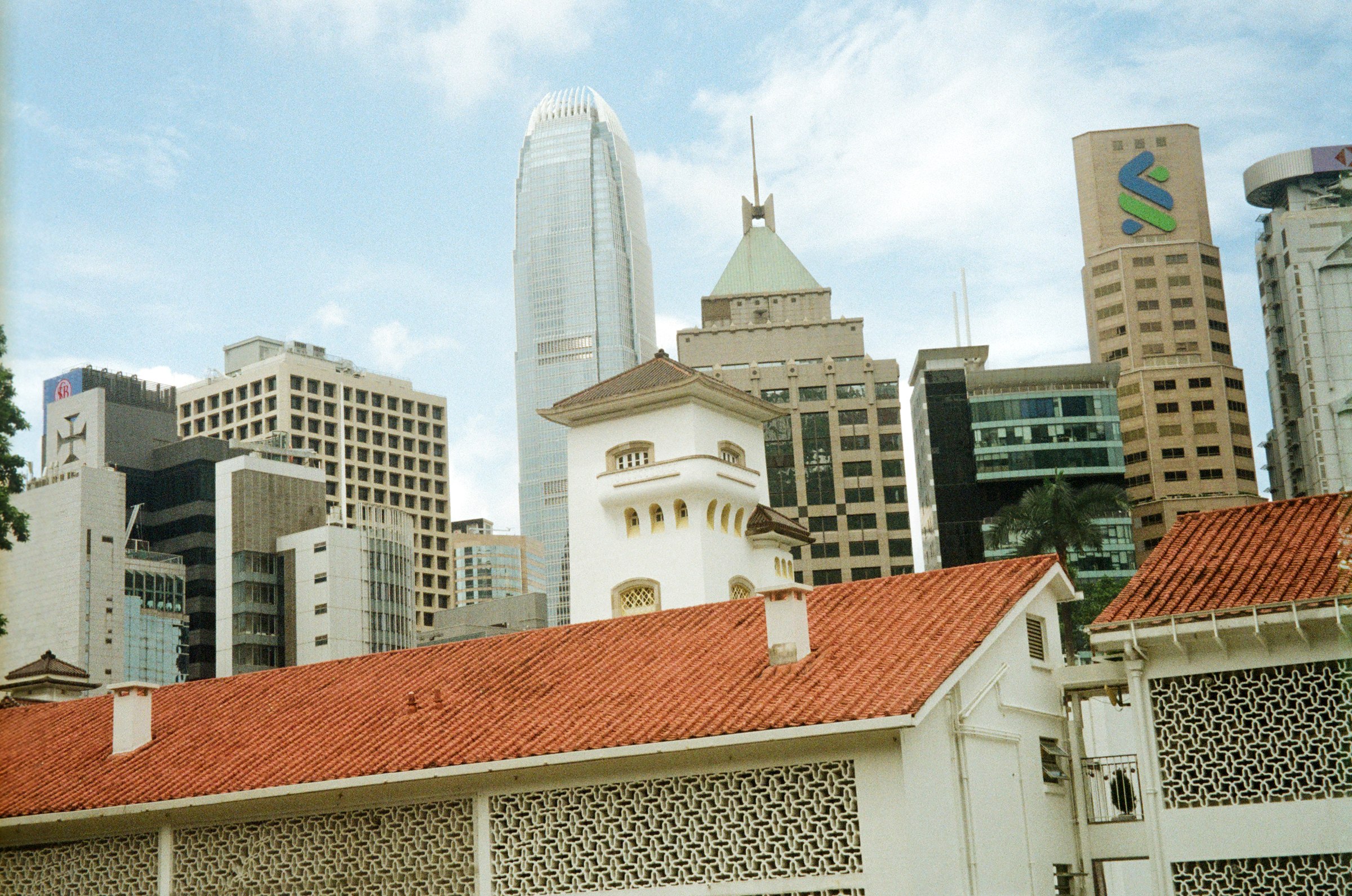 A red tiled roof against the modern skyline behind